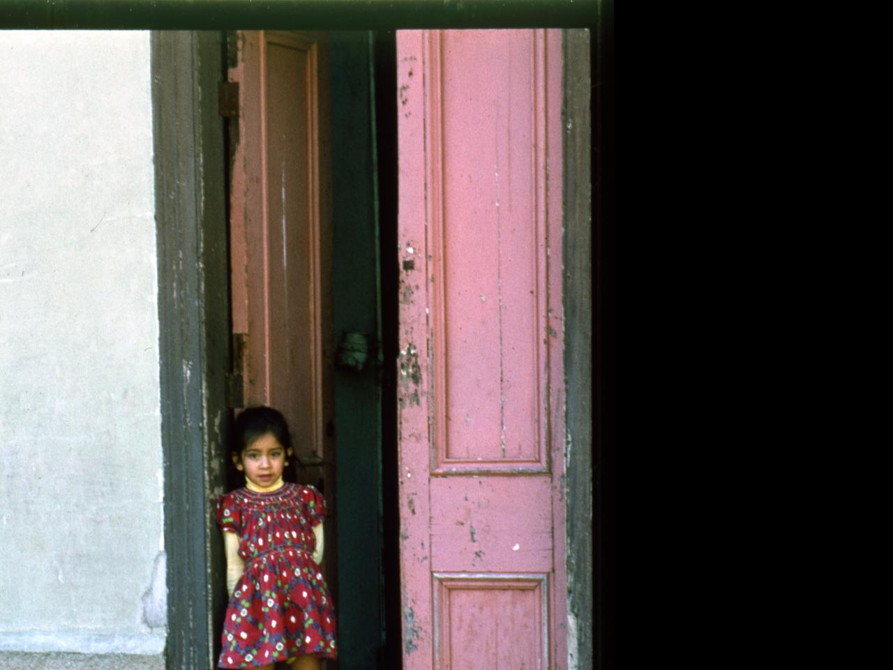 Niña en la puerta de su casa / Avenida Francia